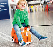 Child sitting on a Trunki Suitcase